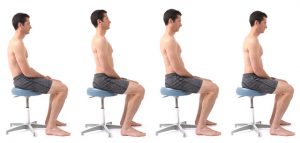 Demonstrates four different sitting postures; man sitting on stool.